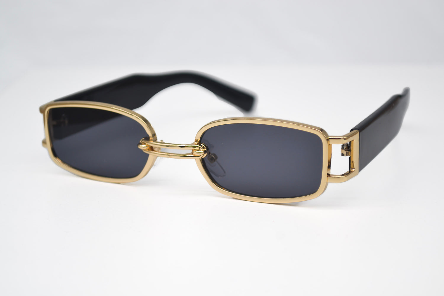 Black rectangle sunglasses with gold rims, sleek design for a modern, sophisticated look.