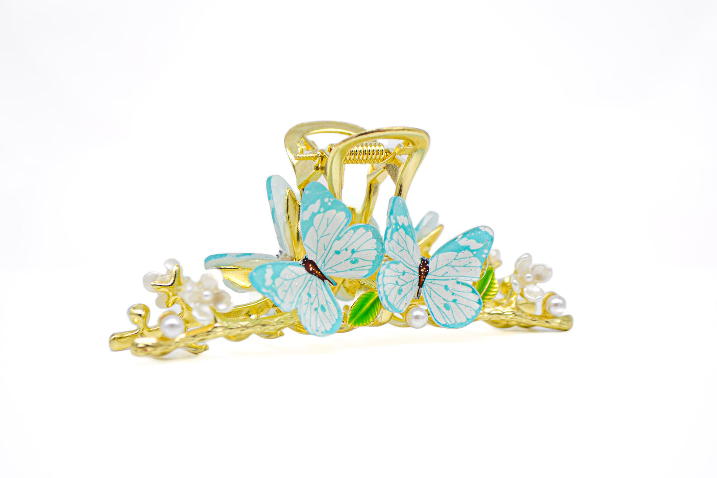 Gold metal claw clip adorned with delicate blue butterfly accents.