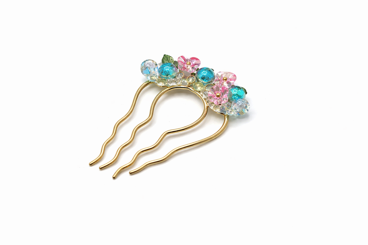 Decorative hairpin with colorful gemstones on a white background