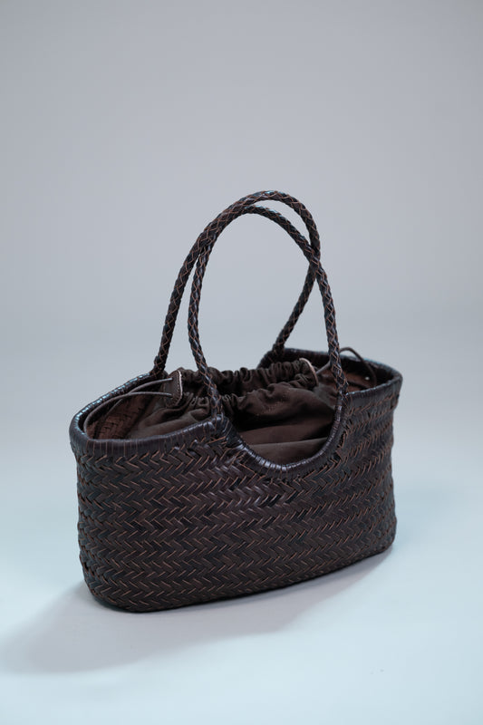 handwoven brown leather tote with braided handles and drawstring lining
