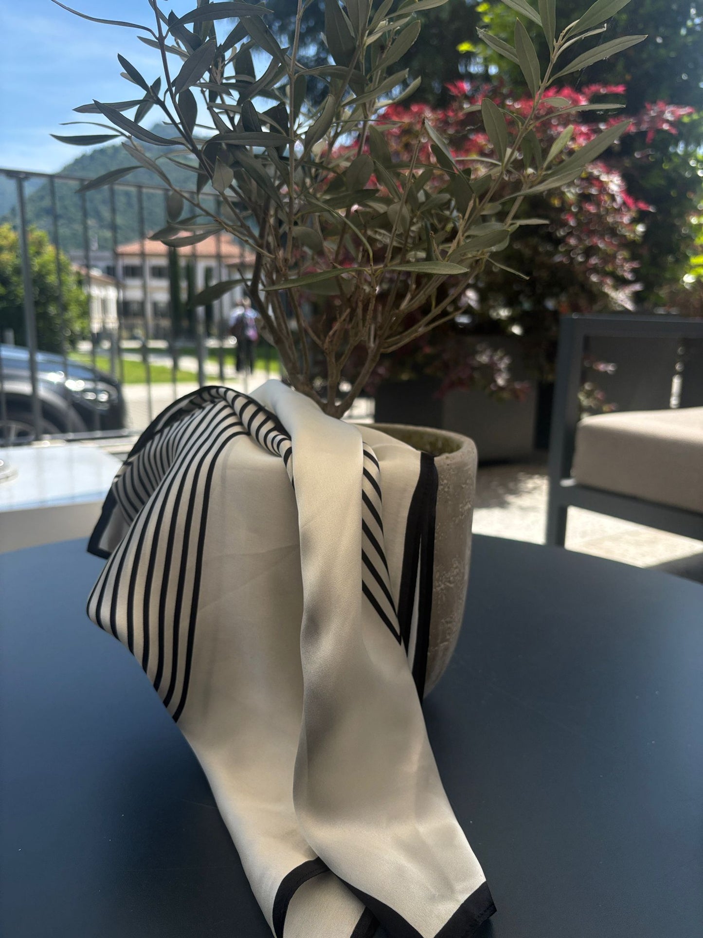 Silk scarf draped elegantly over a decorative vase