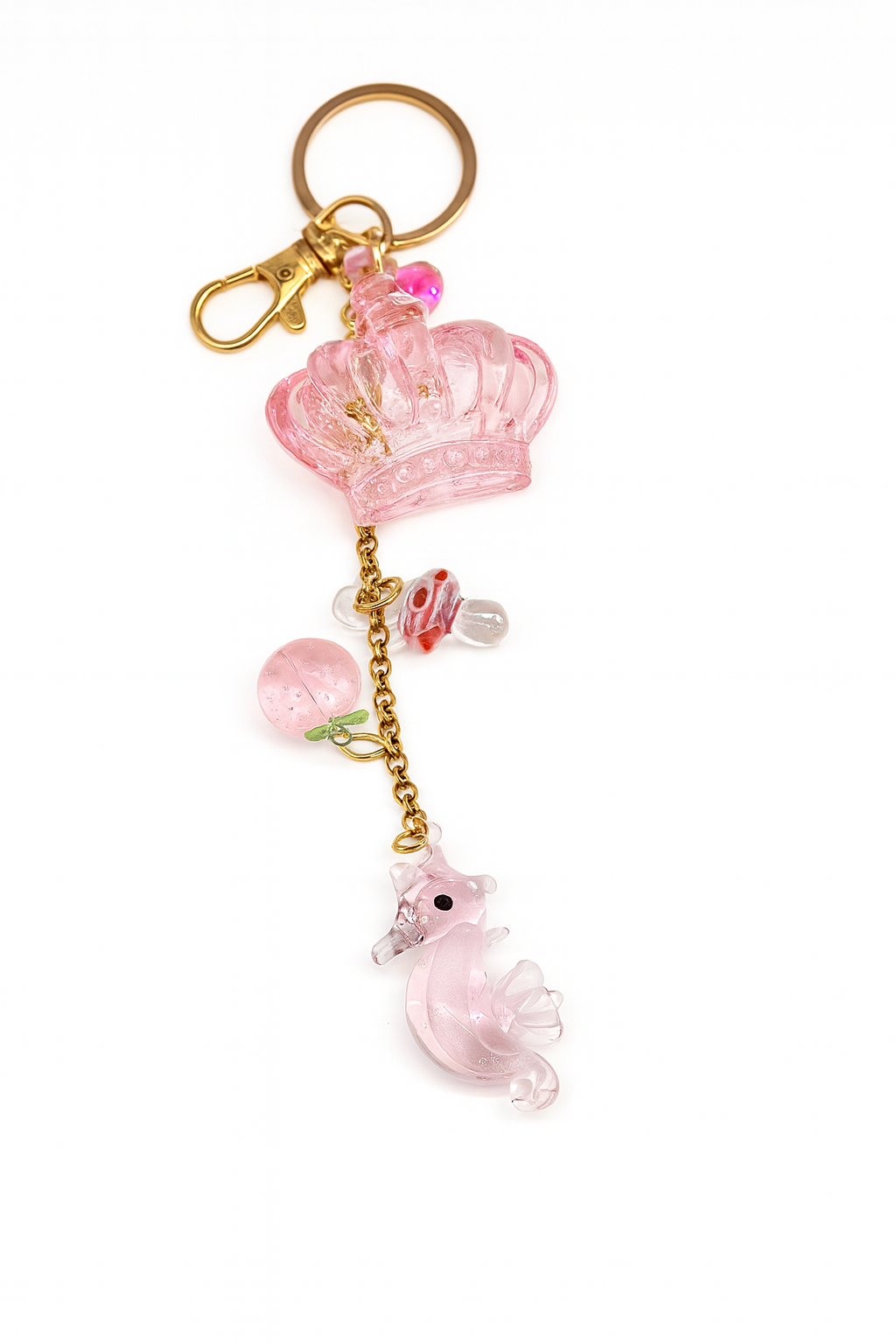 Pink crown keychain with gold-plated chain, lampwork seahorse pendant, and strawberry charm made in Janizuka Shop