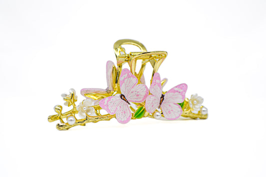 Gold metal hair clip adorned with delicate pink butterfly accents.