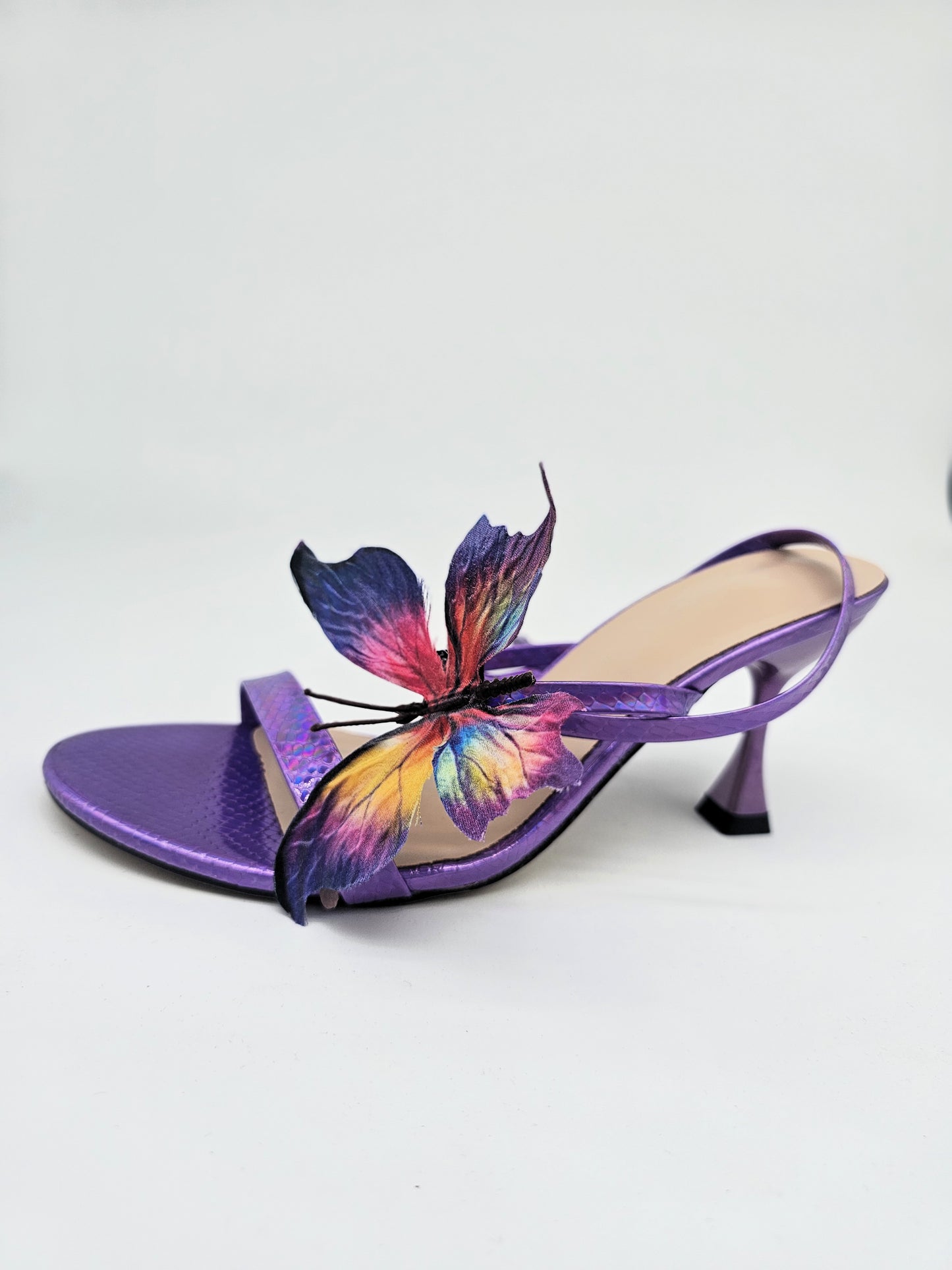 Colorful butterfly heels with metallic purple straps and comfortable insole, bold sandals for casual and dressy wear.