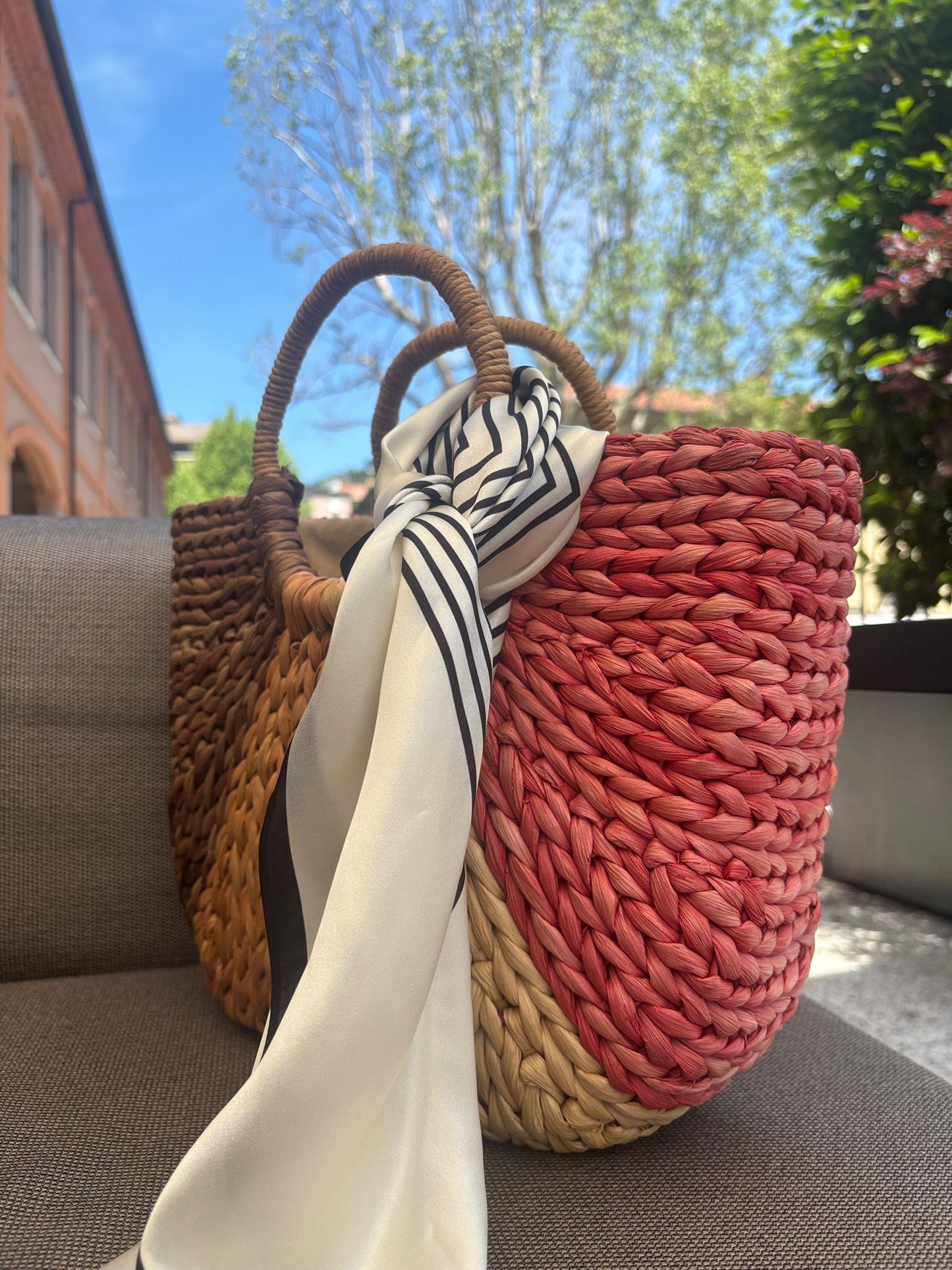 Silk scarf tied on handbag handle for a stylish touch