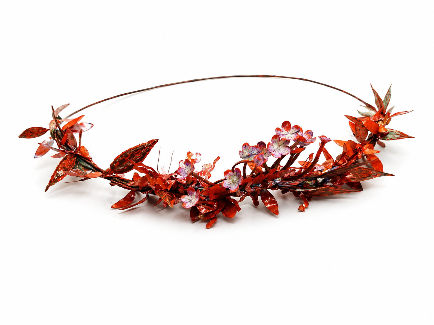 Decorative headband with red floral elements on a white background